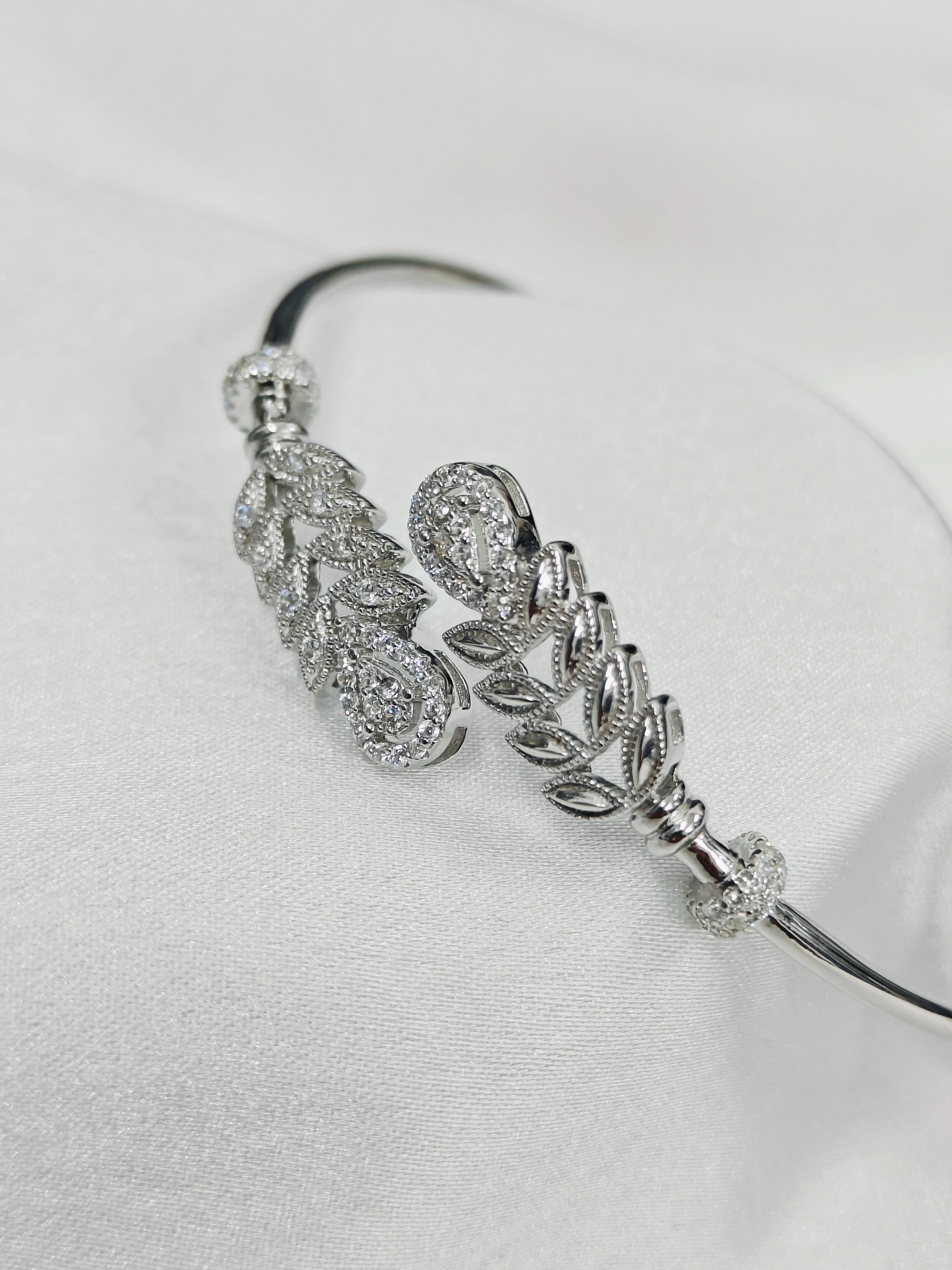 Silver headband with decorative elements on a light gray background